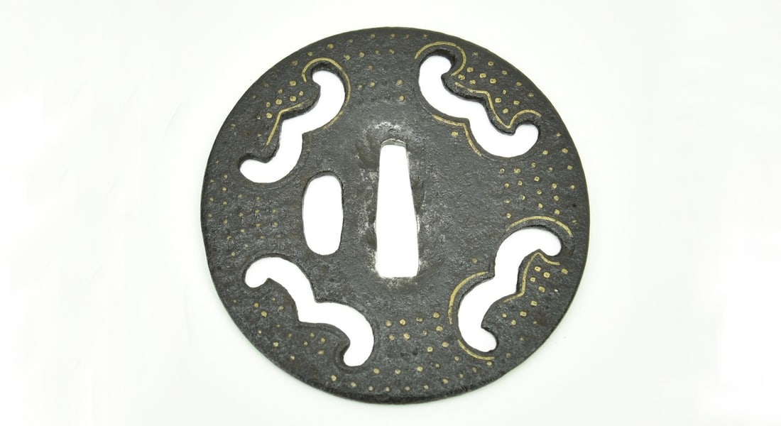 ROUND IRON SUKASHI ONIN SCHOOL TSUBA: Round iron sukashi Onin School Tsuba Description: Tsuba. Round iron sukashi. Onin School. Brass inlay. Unsigned. Muromachi period. 1392-1572. Thin tsuba (early). Good condition. 7.9cm 3” 