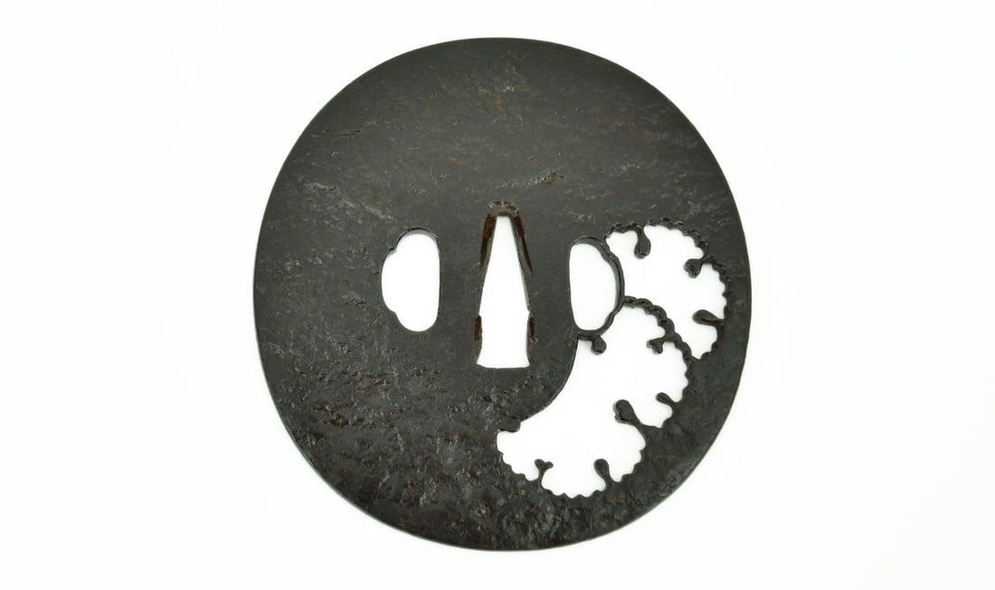 IRON SUKASHI TSUBA MELLOW MOTIF: Iron Sukashi Tsuba Mellow Motif Description: Iron Sukashi Tsuba Mellow Motif. Diameter: 8.9 cm, 3 ½”. Size: Motif. Diameter: 8.9 cm, 3 ½” Accessories: None Accessories