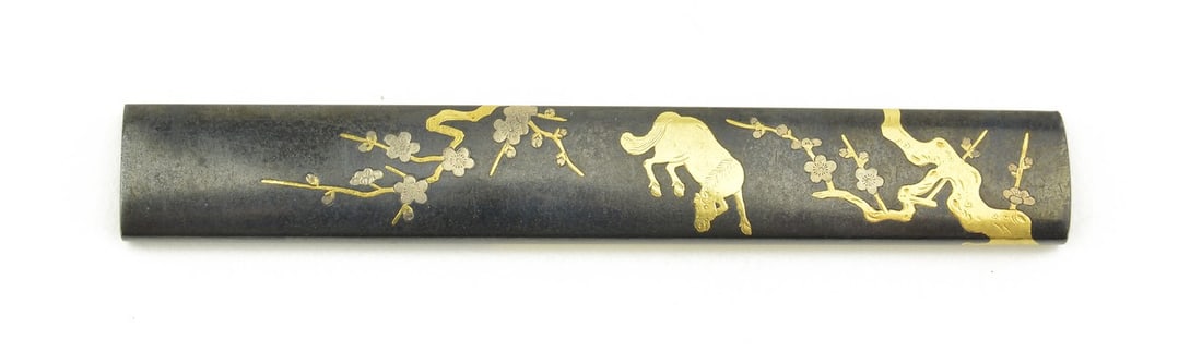 KINKO KODZUKA: Kinko Kodzuka Description: Kinko Kodzuka. Polished shakudo ground. Gold and silver inlay. Kaga Zogan. Unsigned. Attribution by N.B.T.H.K. to Kaga issued in 1972. Size: None Accessories: None