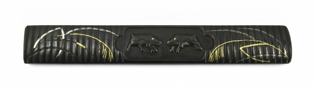 KINKO KODZUKA: Kinko Kodzuka Description: Kinko Kodzuka. Polished shakudo ground. Shakudo boars with gold eyes. Gold and silver foliage missing small inlay. Reverse has gold and silver inlay. Size: None 