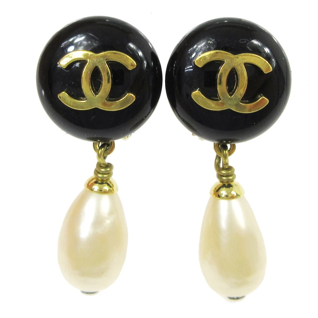 CHANEL ARTIFICIAL PEARL DANGLE EARRINGS CLIP-ON: Chanel Artificial Pearl Dangle Earrings Clip-On Brand: Chanel Type: Earrings Material: Gold-tone Plastic Main Stone/Creation Artificial Pearl Color: Gold, Black, White Size: W 1.5 x H 3.5 cm Acce