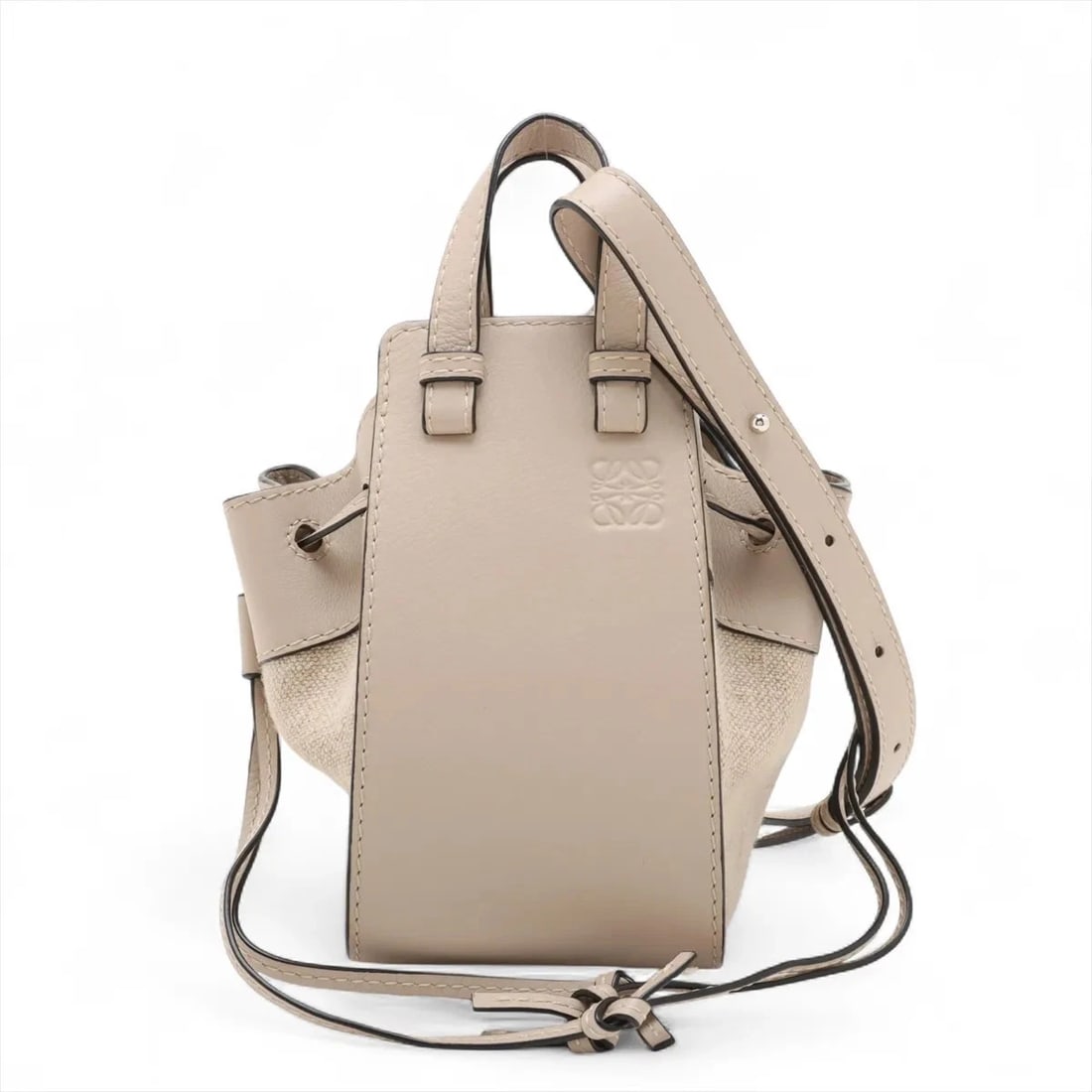 LOEWE HAMMOCK DRAWSTRING MINI LEATHER X CANVAS 2 WAY HANDBAG: Loewe Hammock Drawstring mini leather x canvas 2 Way Handbag Brand: Loewe Type: Hand bag Material: Leather Color: Beige Size: Height:7.5inch Length:4.1inch Depth:7.1inch Handle height:2.4inch Shou