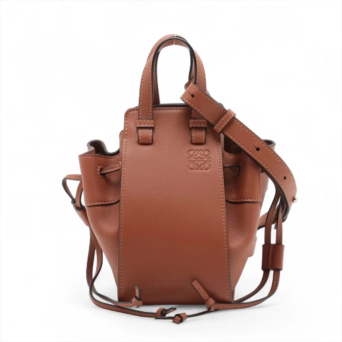 LOEWE HAMMOCK DRAWSTRING MINI LEATHER 2 WAY HANDBAG: Loewe Hammock Drawstring mini Leather 2 Way Handbag Brand: Loewe Type: Hand bag Material: Leather Color: Brown Size: Height:7.3inch Length:4.1inch Depth:6.3inch Handle height:2.4inch Shoulder heig