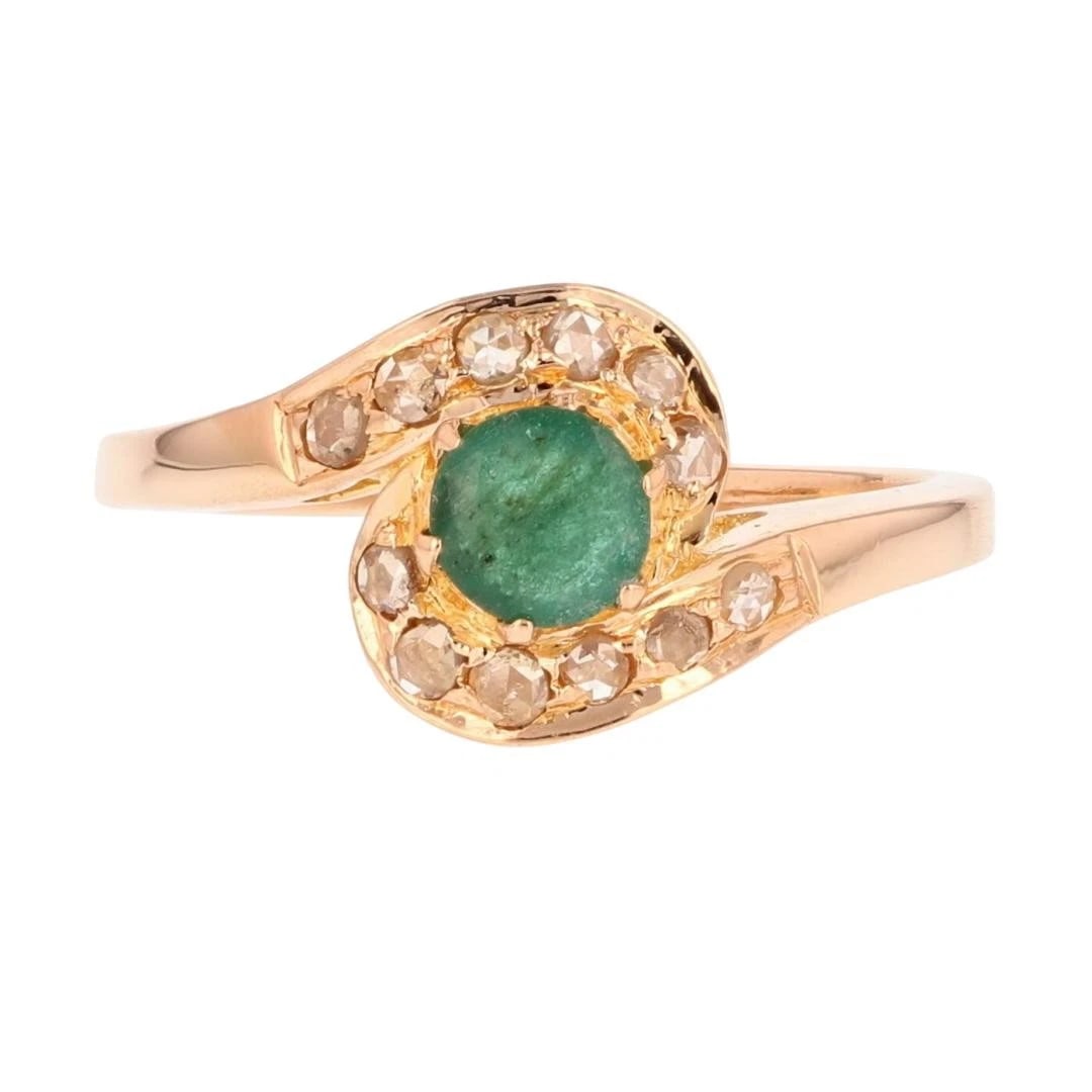 EMERALD SOLITAIRE AND DIAMOND BYPASS STYLE RING: Emerald Solitaire and Diamond Bypass Style Ring Brand: Unbranded Type: Ring Material: 20k Yellow Gold Main Stone/Creation Emerald Color: Main Stone Color: Medium Very Slightly Grayish Green 