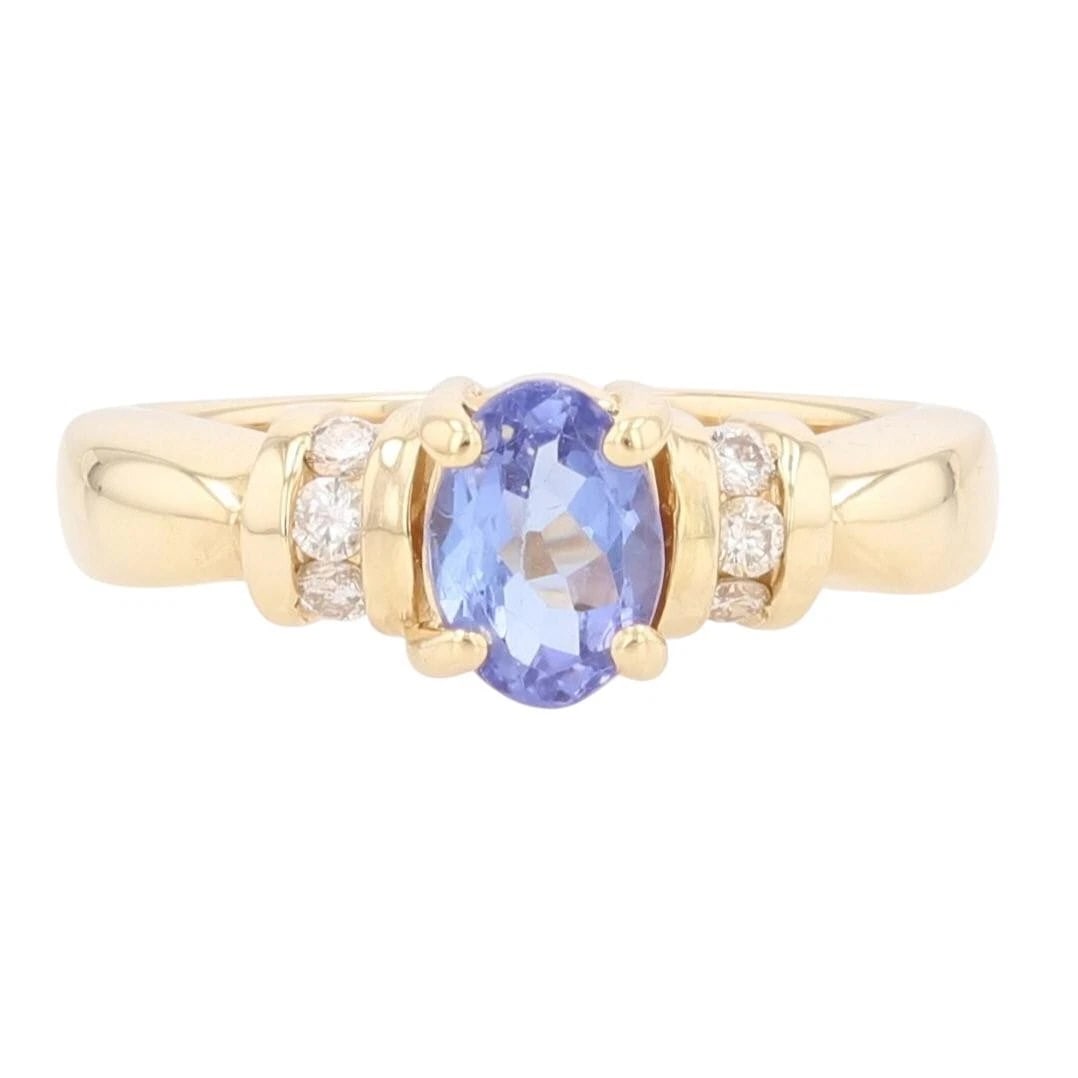 OVAL CUT TANZANITE & DIAMOND ACCENTS COCKTAIL RING: Oval Cut Tanzanite & Diamond Accents Cocktail Ring Brand: Unbranded Type: Ring Material: 14k Yellow Gold Main Stone/Creation Tanzanite Color: Main Stone Color: Medium Very Slightly Grayish