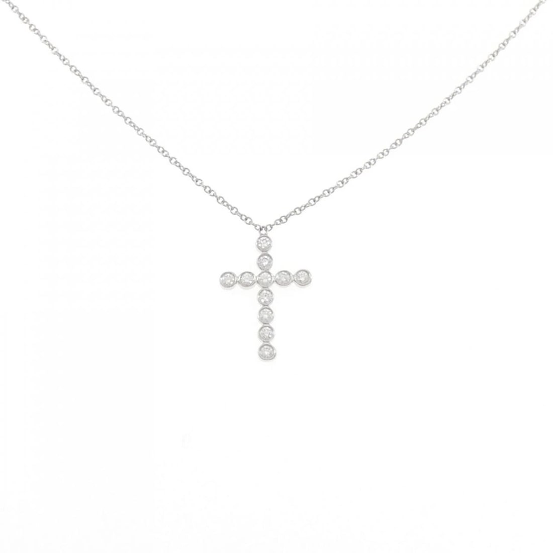 TIFFANY & CO. BEZEL CROSS MINI NECKLACE: Tiffany & Co. bezel Cross mini Necklace Brand: Tiffany Type: Necklace Material: Platinum 950 Main Stone/Creation Natural Color: Platinum Size: 42cm Accessories: None Accessories Notice: When
