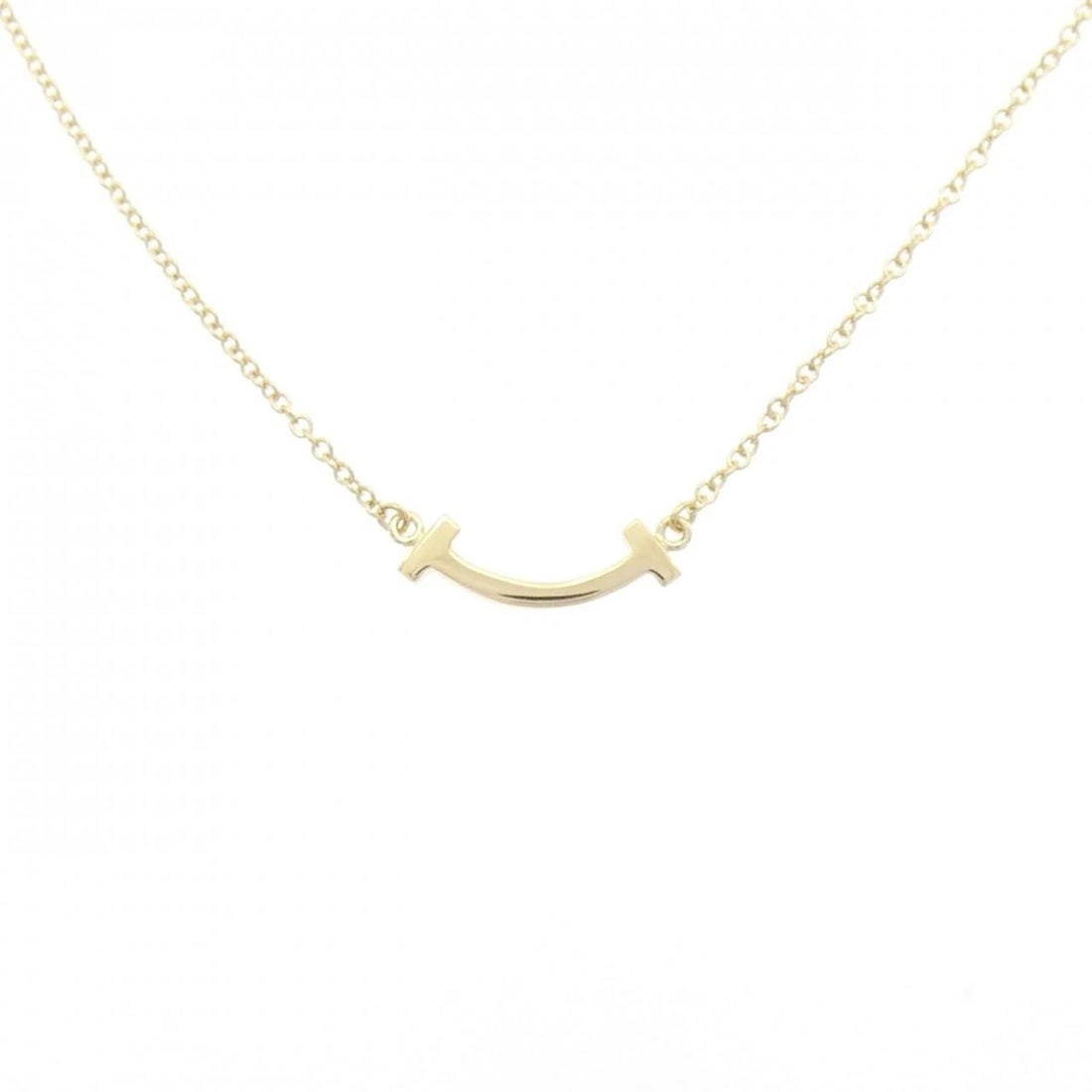 TIFFANY T SMILE MINI NECKLACE: Tiffany T Smile mini Necklace Brand: Tiffany Type: Necklace Material: 750 Yellow Gold Color: Yellow Gold Size: 40/46cm Accessories: None Accessories Notice: When purchasing pre-owned goods,