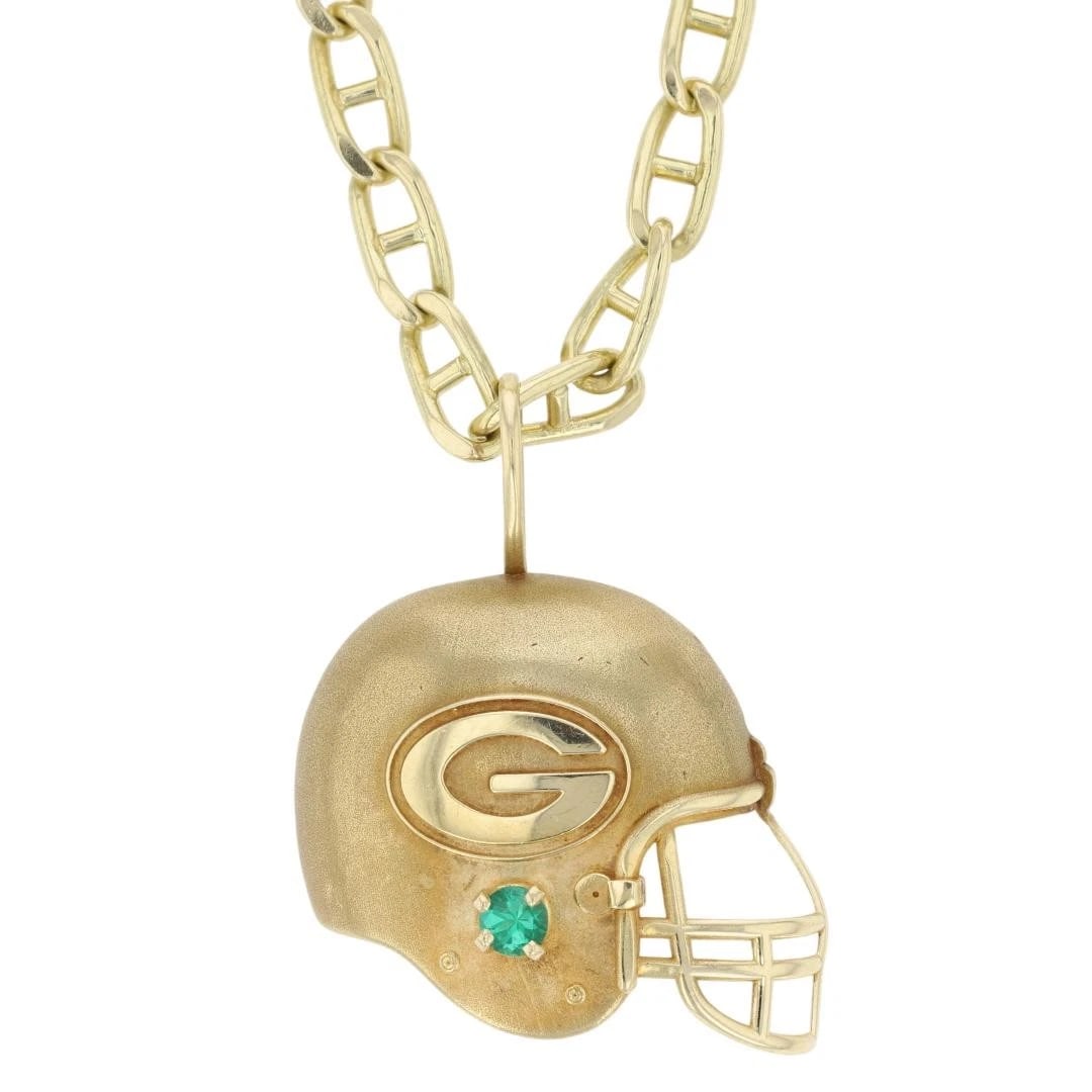 LAB-CREATED EMERALD GREEN BAY PACKERS HELMET NECKLACE: Lab-Created Emerald Green Bay Packers Helmet Necklace Brand: Michael Anthony Type: Necklace Material: 14k Yellow Gold Main Stone/Creation Lab-Created Color: Main Stone Color: Vivid Slightly
