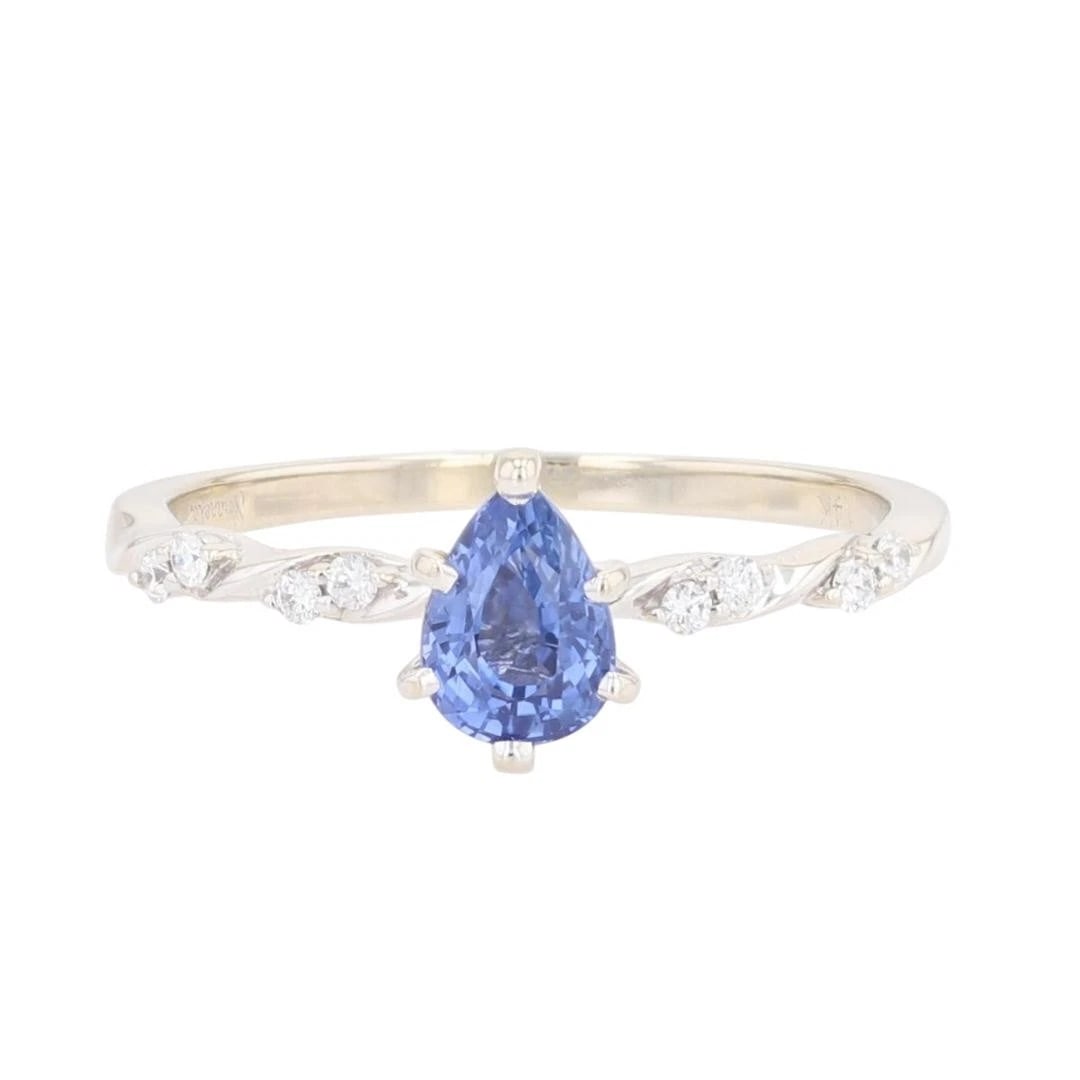 PEAR CUT SAPPHIRE AND DIAMOND STATEMENT RING: Pear Cut Sapphire and Diamond Statement Ring Brand: Unbranded Type: Ring Material: 14k White Gold Main Stone/Creation Sapphire Color: Main Stone Color: Medium Moderately Strong Violetish Blue Size