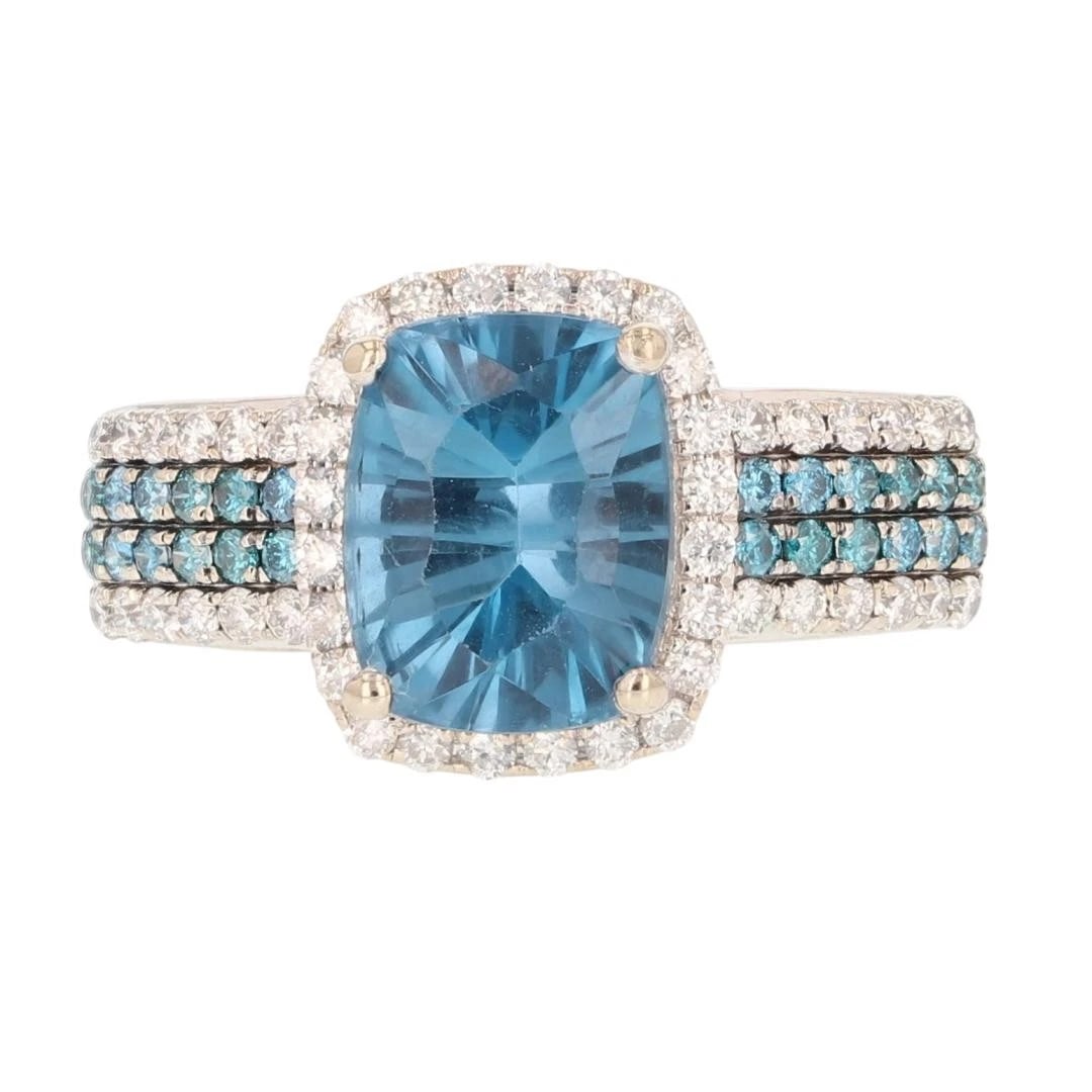 CUSHION CUT BLUE TOPAZ W/ DIAMOND HALO RING: Cushion Cut Blue Topaz w/ Diamond Halo Ring Brand: Unbranded Type: Ring Material: 14k White Gold Main Stone/Creation Blue Topaz Color: Main Stone Color: Blue Size: 9.75 US Accessories: None