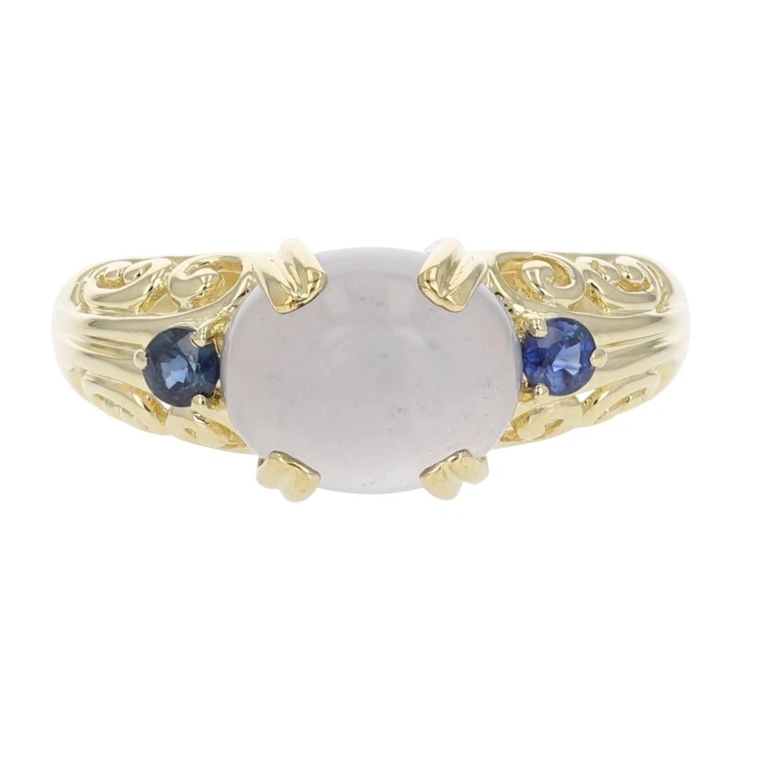 CABOCHON CHALCEDONY W/ SAPPHIRE ACCENTS RING: Cabochon Chalcedony w/ Sapphire Accents Ring Brand: Unbranded Type: Ring Material: 14k Yellow Gold Main Stone/Creation Natural Color: Main Stone Color: Medium Light Slightly Grayish Bluish