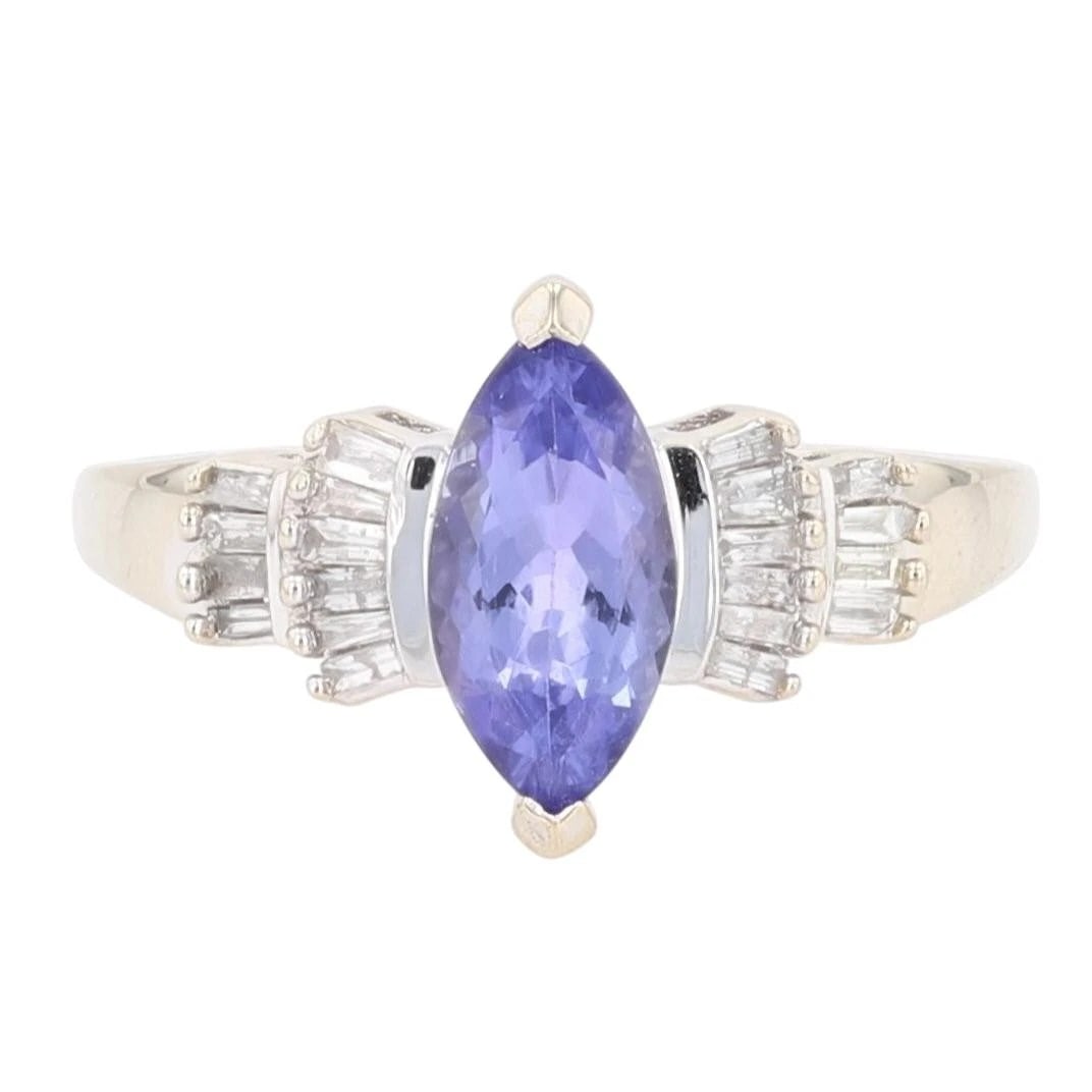 MARQUISE CUT TANZANITE WITH DIAMOND ACCENTS RING: Marquise Cut Tanzanite with Diamond Accents Ring Brand: Unbranded Type: Ring Material: 14k White Gold Main Stone/Creation Tanzanite Color: Main Stone Color: Medium Slightly Grayish Violet 