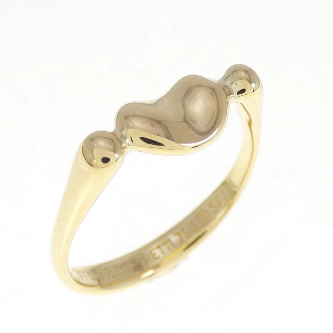 TIFFANY BEANS RING: Tiffany Beans Ring Brand: Tiffany Type: Ring Material: 750 Yellow Gold Color: Yellow Gold Size: 5-5.5 (US size) Accessories: None Accessories Notice: When purchasing pre-owned goods, please