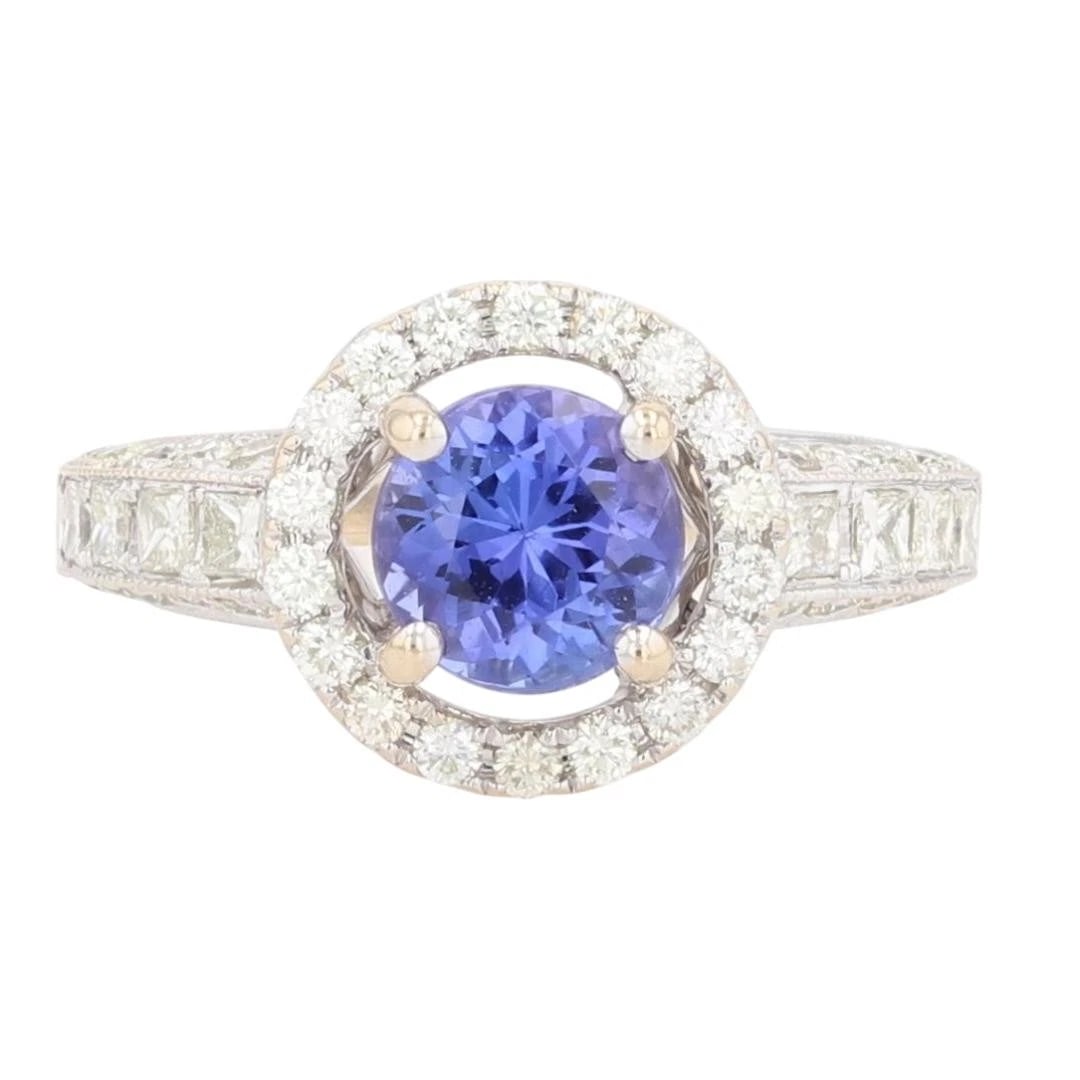 ROUND TANZANITE AND DIAMOND HALO STATEMENT RING: Round Tanzanite and Diamond Halo Statement Ring Brand: Unbranded Type: Ring Material: 18k White Gold Main Stone/Creation Tanzanite Color: Main Stone Color: Medium Moderately Strong Bluish Violet S