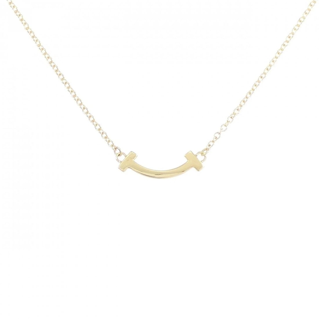 TIFFANY T SMILE MINI NECKLACE: Tiffany T Smile mini Necklace Brand: Tiffany Type: Necklace Material: 750 Yellow Gold Color: Yellow Gold Size: 41/46cm Accessories: None Accessories Notice: When purchasing pre-owned goods,