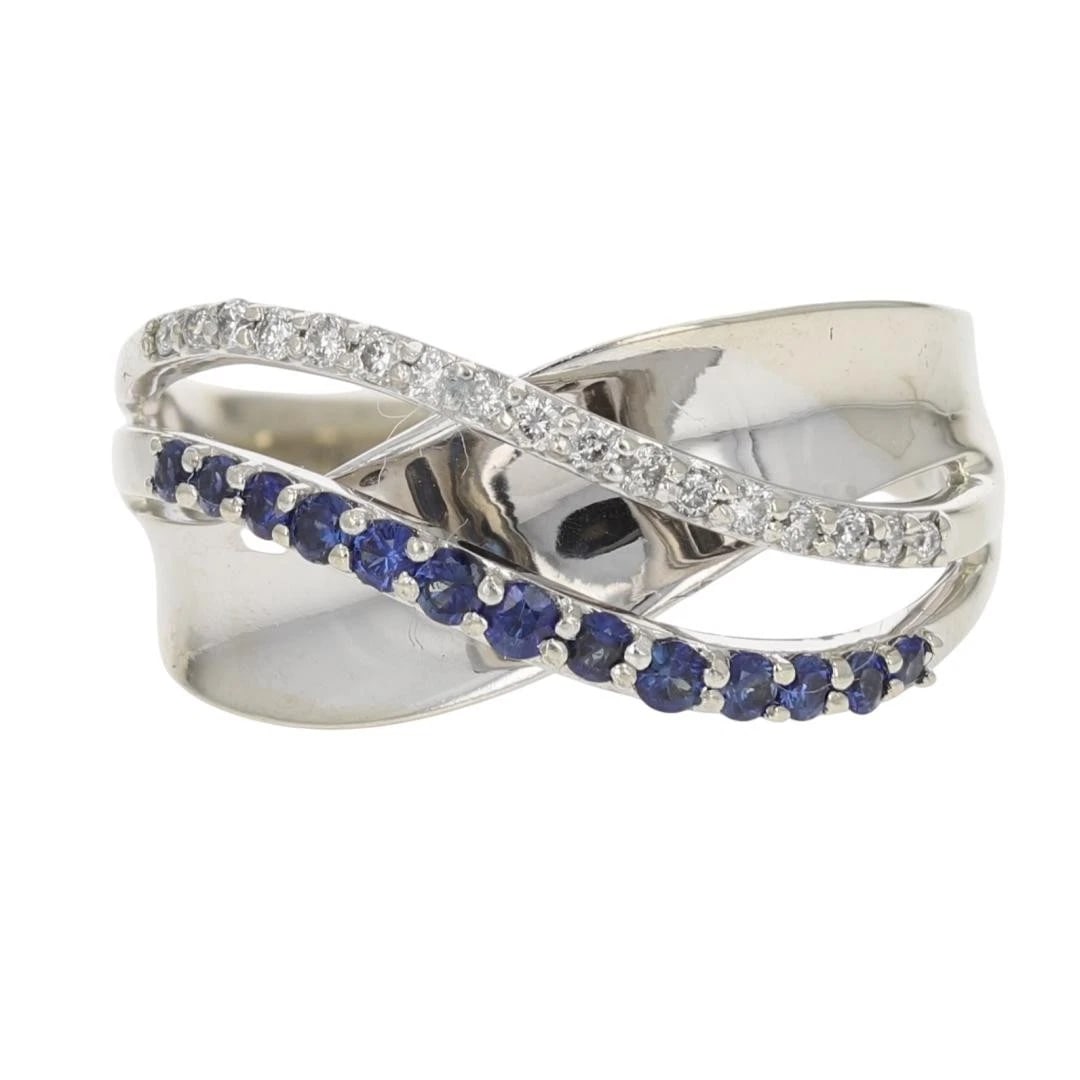 ROUND CUT SAPPHIRE AND DIAMOND CROSSOVER RING: Round Cut Sapphire and Diamond Crossover Ring Brand: Unbranded Type: Ring Material: 14k White Gold Main Stone/Creation Sapphire Color: Main Stone Color: Blue Size: 6.5 US Accessories: None