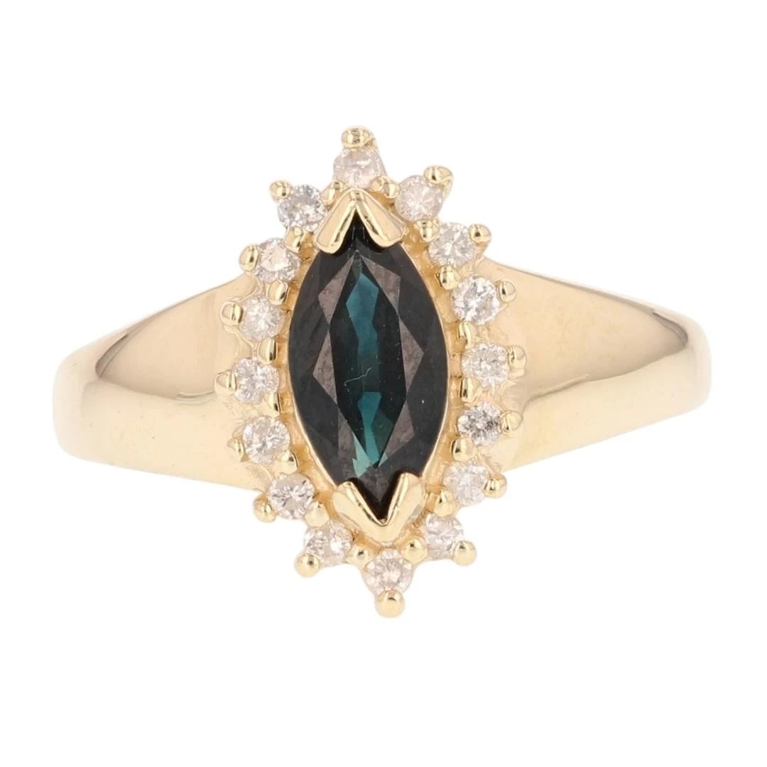 MARQUISE CUT SAPPHIRE DIAMOND HALO RING: Marquise Cut Sapphire Diamond Halo Ring Brand: Unbranded Type: Ring Material: 14k Yellow Gold Main Stone/Creation Sapphire Color: Main Stone Color: Dark Greenish Blue Size: 9 US Accessories:
