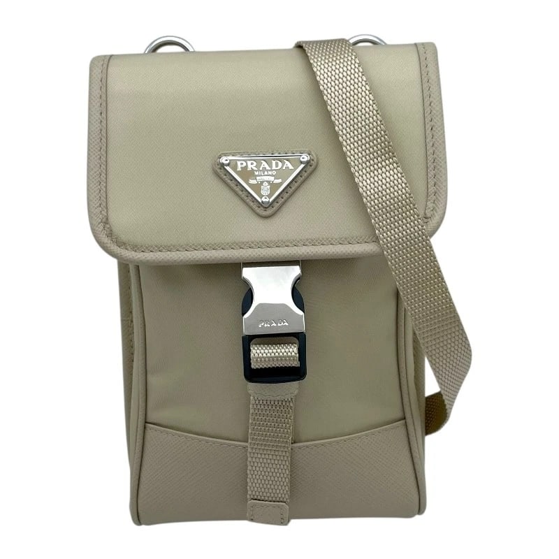 PRADA PHONE SHOULDER BAG: PRADA Phone Shoulder Bag Brand: PRADA Type: Shoulder Bag Material: Linylon Sapphire Color: beige Size: W4.3 x H3.5x D1.2inch Shoulder:55.1inch Accessories: None Accessories Notice: When