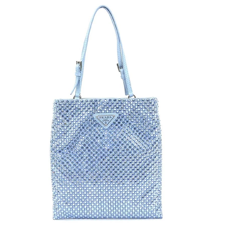 PRADA HANDBAG LIGHT BLUE SATIN/RHINESTONE/SILVERTONE: PRADA Handbag Light Blue Satin/Rhinestone/Silvertone Brand: PRADA Type: Handbag Material: Satin x Rhinestone Color: Light Blue Size: W:6.9inx H:7.7in Handle Length:12.6in Accessories: None