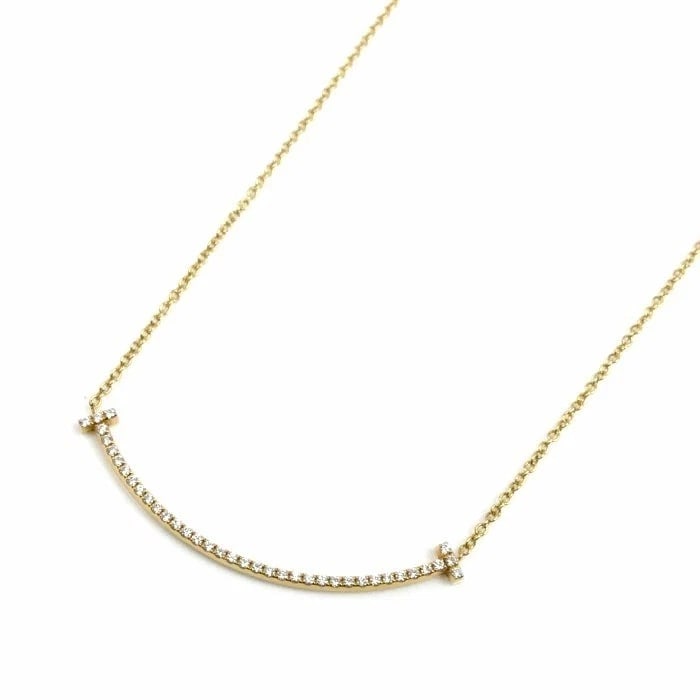 TIFFANY & CO. T SMILE SMALL DIAMOND NECKLACE K18 YELLOW GOLD: Tiffany & Co. T Smile Small Diamond Necklace K18 Yellow Gold Brand: Tiffany & Co. Type: Necklace Material: K18 Yellow Gold Main Stone/Creation Natural Color: Yellow Gold Size: Chain Length: 15.75