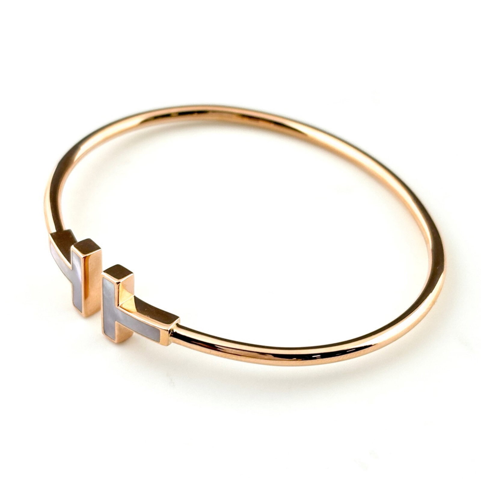TIFFANY & CO. T-WIRE BANGLE IN PG PINK GOLD: Tiffany & Co. T-Wire Bangle in PG Pink Gold, Brand: Tiffany Type: Bangle Material: Pink gold (18K) Color: Pink gold Size: Length 15cm / 5.9'' Accessories: None Accessories Notice: When