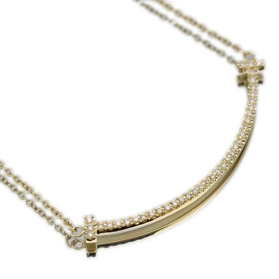 TIFFANY & CO. 18K YELLOW GOLD MOTIF NECKLACE: Tiffany & Co. 18K Yellow Gold Motif Necklace Brand: Tiffany & Co. Type: Necklace Material: 18K Yellow Gold Color: Yellow Gold Size: Pendant Size: Approx. 1.46 in (37 mm) Chain Length: Adjustable a