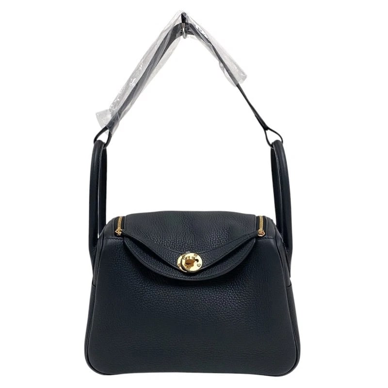 HERMES LINDY 26 SHOULDER BAG: HERMES Lindy 26 Shoulder Bag Brand: HERMES Type: Shoulder Bag Material: Taurillon Clemence Color: Black Gold Hardware Size: W10.2 x H7.1x D5.1inch Accessories: None Accessories Notice: When