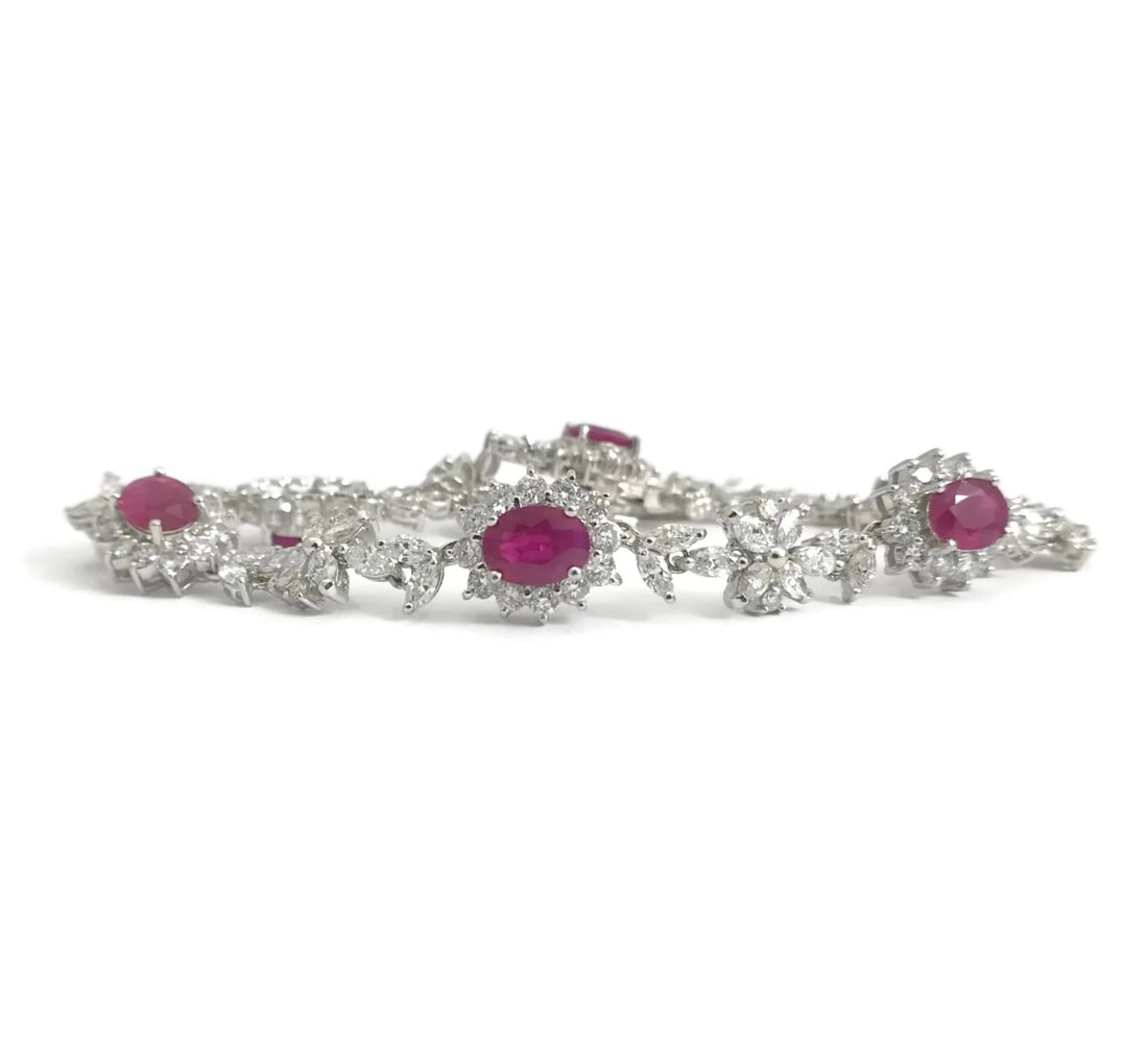 OVAL RUBY AND DIAMOND HALO FLOWER BRACELET 18K: Oval Ruby and Diamond Halo Flower Bracelet 18K Brand: Unbranded Type: Bracelet Material: 18K white gold Main Stone/Creation Natural Color: Red Size: Length: 7.75 inches Width: 10.8 mm at