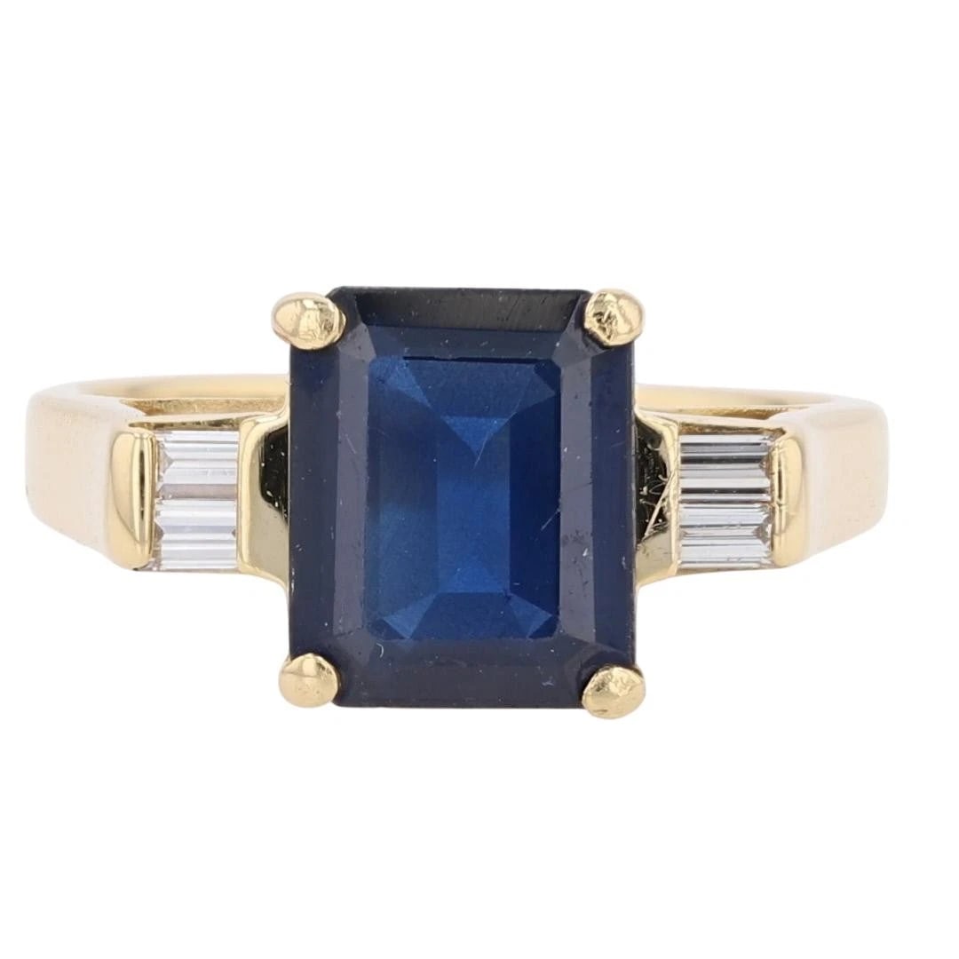 GIA EMERALD SAPPHIRE WITH DIAMOND ACCENTS RING: GIA Emerald Sapphire with Diamond Accents Ring Brand: Unbranded Type: Ring Material: 18k Yellow Gold Main Stone/Creation Sapphire Color: Main Stone Color: Blue Size: 7.25 US Accessories: None