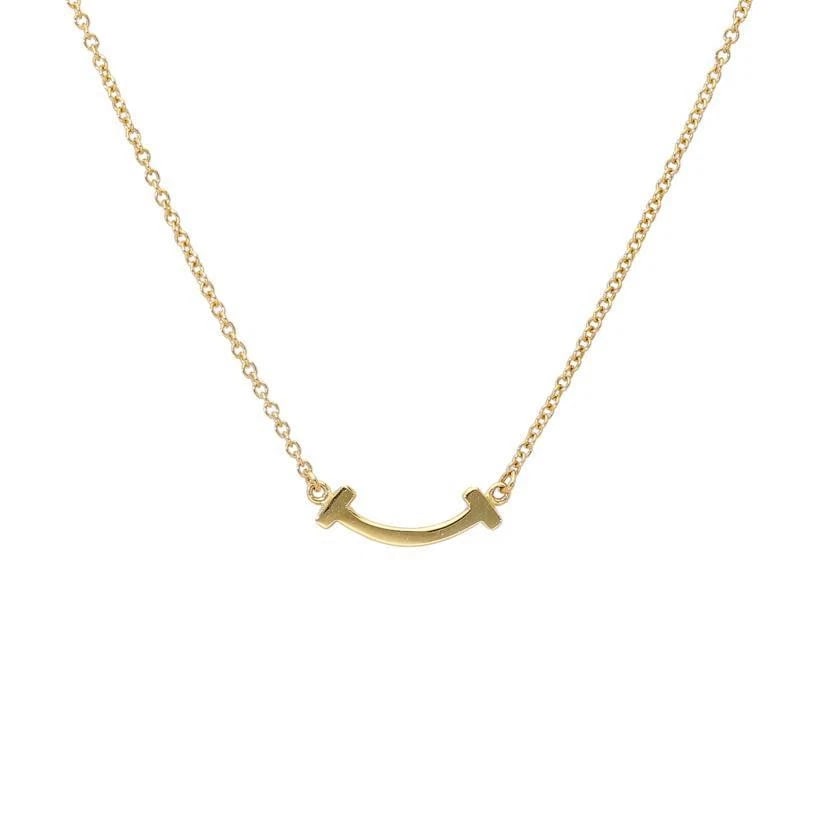 TIFFANY & CO. T SMILE MINI K18 GOLD LADIES NECKLACE: Tiffany & Co. T Smile Mini K18 Gold Ladies Necklace Brand: Tiffany & Co. Type/Style: Necklace Material: Metal Purity K18, Metal Gold, Main Stone/Creation Natural Color: Gold Size: NecklaceChain Le