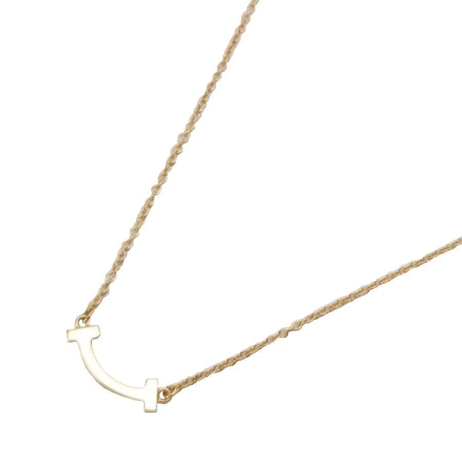 TIFFANY & CO. T SMILE K18 YELLOW GOLD NECKLACE: Tiffany & Co. T Smile K18 Yellow Gold Necklace Brand: Tiffany & Co. Type/Style: Necklace Material: Metal Purity K18, Metal Yellow Gold, Main Stone/Creation Natural Color: Yellow Gold Size: Total L