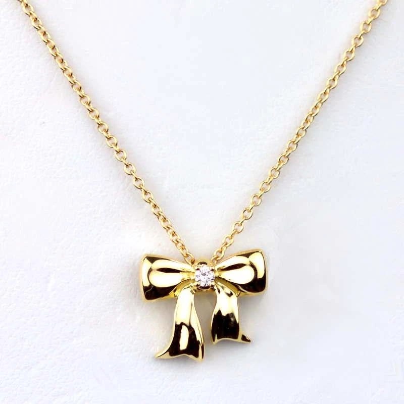 TIFFANY & CO. BLUE BOX BOW RIBBON DIAMOND NECKLACE: Tiffany & Co. Blue Box Bow Ribbon Diamond Necklace Brand: Tiffany & Co. Type/Style: Necklace Material: Metal Purity K18, Metal Yellow Gold, Color: Yellow Gold Size: Total length: approx. 40cmTop: