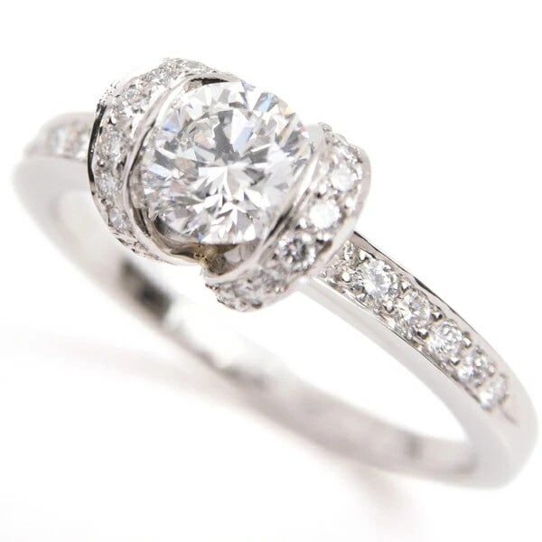 TIFFANY & CO. RIBBON MOTIF DIAMOND RING: Tiffany & Co. Ribbon Motif Diamond Ring Brand: Tiffany & Co. Type/Style: Ring Material: Metal Purity Pt950, Metal Platinum, Main Stone/Creation Natural Color: Platinum Size: US 7.5 Accessories: N