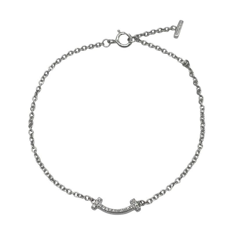TIFFANY & CO. T SMILE DIAMOND 750WG BRACELET: Tiffany & Co. T Smile Diamond 750WG Bracelet Brand: Tiffany & Co. Type/Style: Bracelet Material: Metal Purity 925, Metal White Gold, Main Stone/Creation Natural Color: White Gold Size: Length: App