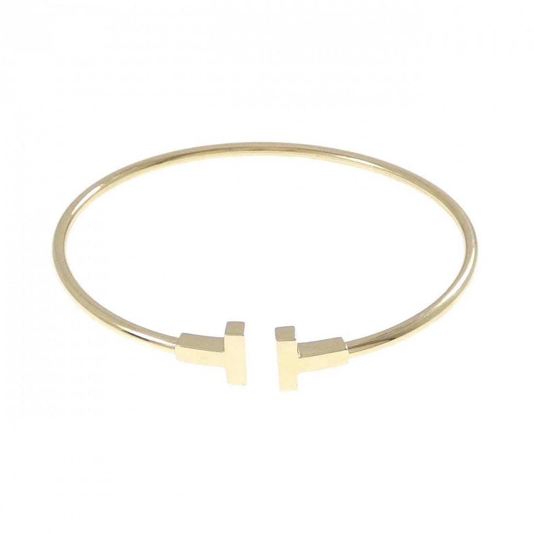 TIFFANY T NARROW WIRE BANGLE: Tiffany T Narrow wire Bangle Brand: Tiffany Type: Bracelet Material: 750 Yellow Gold, Color: Yellow Gold Size: ActualSize Max W: 9.6mm Size18cm Accessories: None Accessories Notice: When