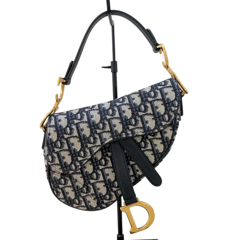 CHRISTIAN DIOR MINI SADDLE BAG NAVY GHW TROTTER/JACQUARD HANDBAG: Christian Dior Mini Saddle Bag Navy GHW Trotter/Jacquard Handbag Brand: CHRISTIAN DIOR Type: Handbag Material: Trotter/Jacquard Color: Navy/GD Hardware Size: W: 15cm / H: 13cm / D: 3cm / Shoulder: