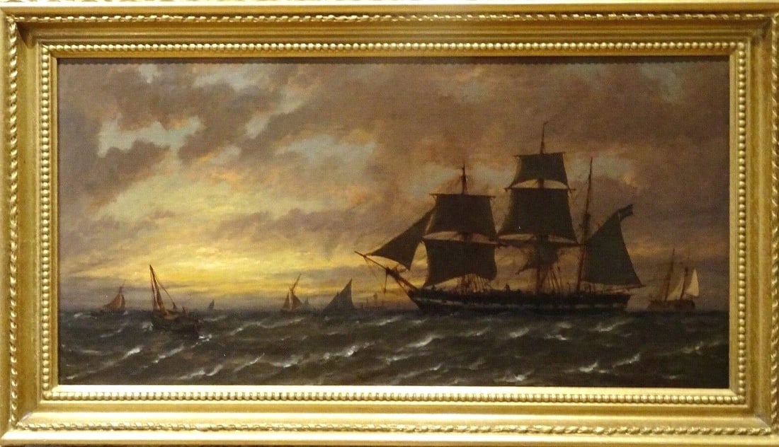 SHIPS AT SUNSET OIL PAINTING: Year: 16th century Size: 32" x 17" Medium: Oil Description: Richard Henry Nibbs' oil painting from the 19th century depicts a variety of ships off the shore at sunset on placid waters. An outstanding