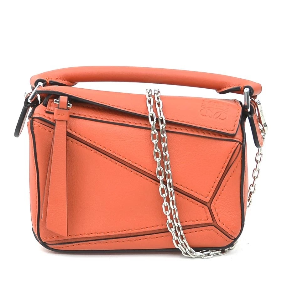 LOEWE PUZZLE BAG NANO CROSSBODY SHOULDER BAG: LOEWE Puzzle Bag Nano Crossbody Shoulder Bag Brand: LOEWE Type: Shoulder Bag Material: Leather Color: Orange Size: W:5.3inx H:3.7inx D:2.6in Handle Length:6.3in Accessories: None Accessori