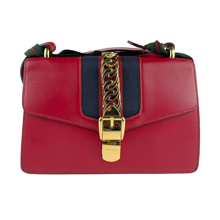 GUCCI SYLVIE SHOULDER BAG RED LEATHER/GOLDTONE SHOULDER BAG: GUCCI Sylvie Shoulder Bag Red Leather/Goldtone Shoulder Bag Brand: GUCCI Type: Shoulder Bag Material: Leather Color: Red Size: W:9.8inx H:6.7inx D:3.1in Handle Length:29.5in Accessories: None