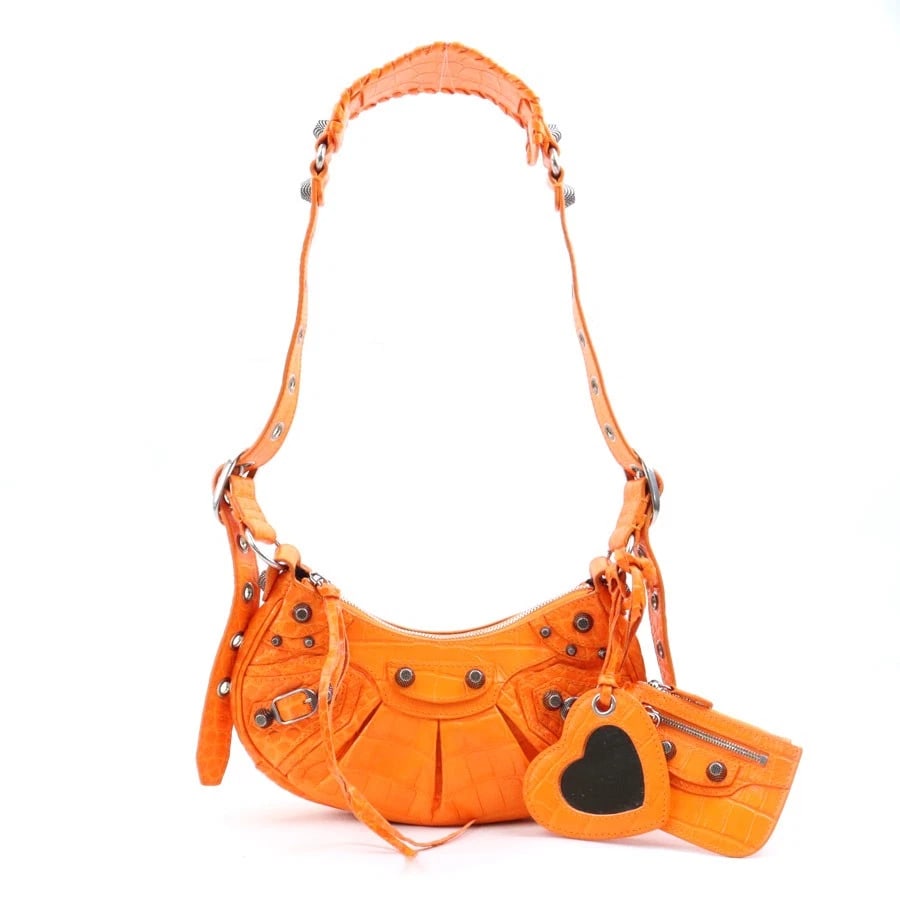 BALENCIAGA LE CAGOLE XS SHOULDER BAG: BALENCIAGA Le Cagole XS Shoulder Bag Brand: BALENCIAGA Type: Shoulder Bag Material: Embossed Leather Color: Orange Size: W:9.4inx H:4.5inx D:2.2in Shoulder Length: 17.3in Accessories: None