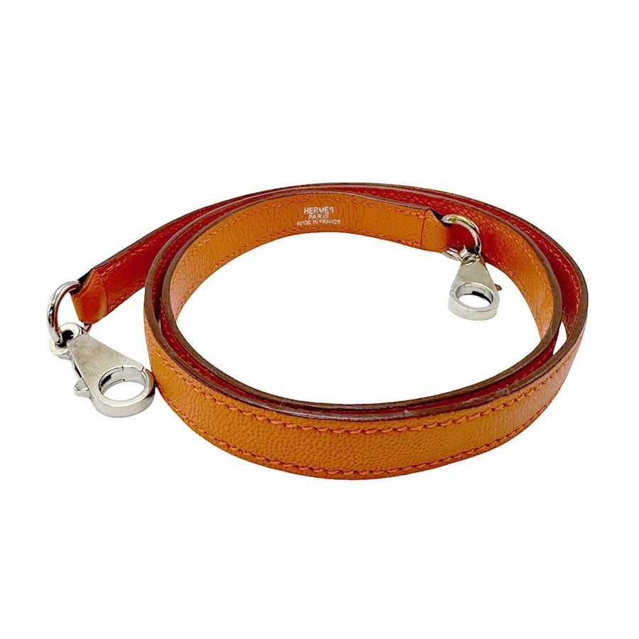 HERMES SHOULDER STRAP ORANGE CHEVRE MYZORE LEATHER/SILVERTONE SHOULDER STRAP: HERMES Shoulder Strap Orange Chevre myzore leather/Silvertone Shoulder strap Brand: HERMES Type: Shoulder strap Material: Chevre myzore leather Color: Orange Size: Length:35.8in Maximum Width:0.4i