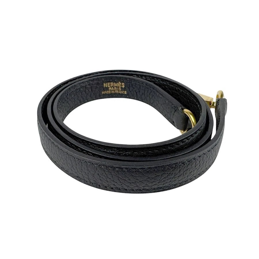 HERMES SHOULDER STRAP BLACK TAURILLON CLEMENCE/GOLDTONE SHOULDER STRAP: HERMES Shoulder Strap Black Taurillon Clemence/Goldtone Shoulder strap Brand: HERMES Type: Shoulder strap Material: Taurillon Clemence Color: Black Size: Length:35.4in Maximum Width:0.6in Accesso
