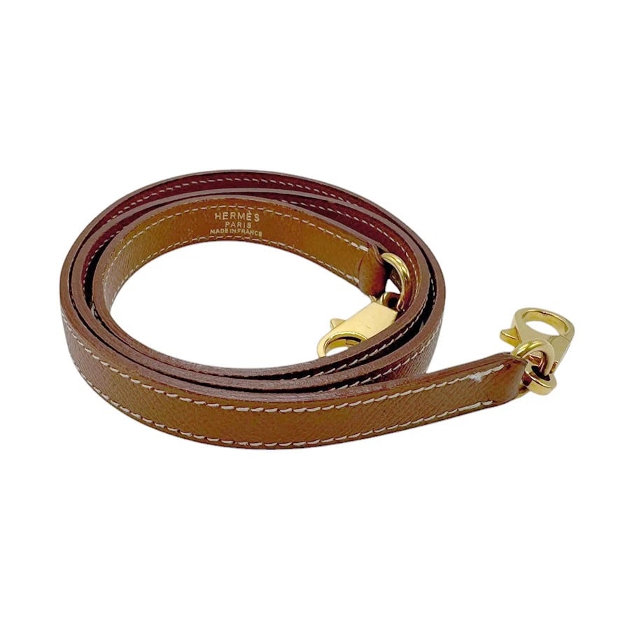 HERMES SHOULDER STRAP GOLD COUCHEVEL LEATHER SHOULDER STRAP: HERMES Shoulder strap gold Couchevel leather Shoulder strap Brand: HERMES Type: Shoulder strap Material: Couchevel leather Color: Gold Size: Length:35.4in Maximum Width:0.4in Accessories: None