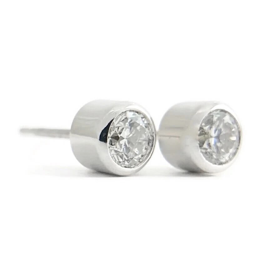 ROUND BEZEL DIAMOND STUD EARRINGS: Round Bezel Diamond Stud Earrings Brand: None Type: Studs Material: 14K white gold, Main Stone/Creation Natural Color: Silver Size: Measurements: 4.5 mm Accessories: None Accessories Notice: