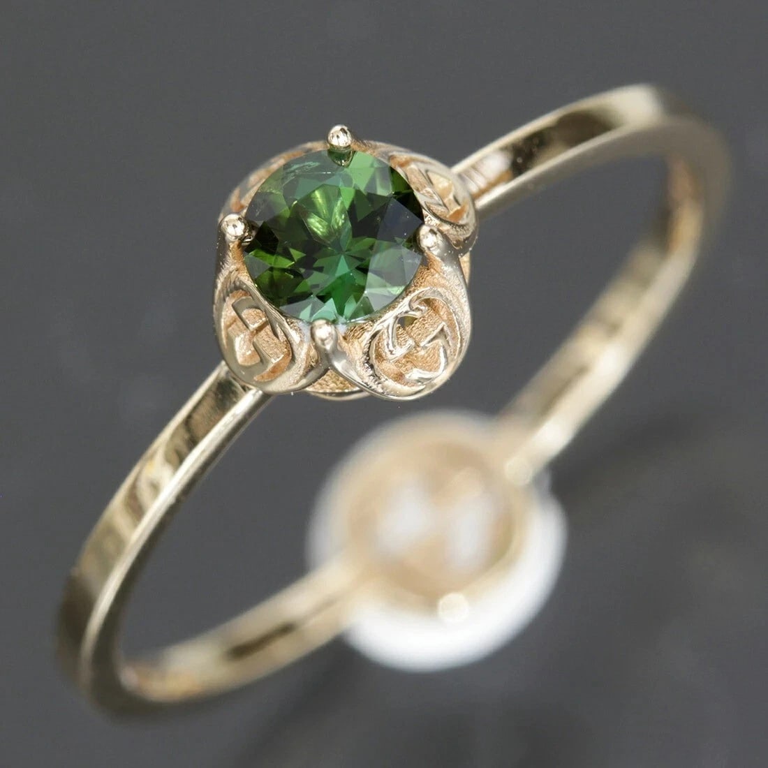 GUCCI INTERLOCKING GREEN TOURMALINE RING: Gucci Interlocking Green Tourmaline Ring Brand: Gucci Type: Ring Material: 18k Yellow Gold Main Stone/Creation Tourmaline Color: Yellow Gold Size: 6.5-7 US Accessories: None Accessories No