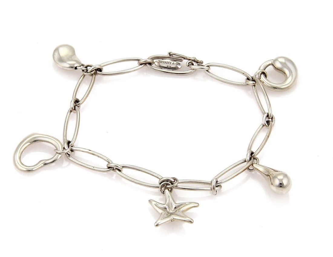 TIFFANY & CO. PERETTI STERLING SILVER OVAL CHAIN BRACELET: Tiffany & Co. Peretti Sterling Silver Oval Chain Bracelet Brand: Tiffany & Co. Type: Bracelet Material: 925 sterling silver Color: none Size: Measurement: 7.25" long x 0.21" wide Charms are: varie