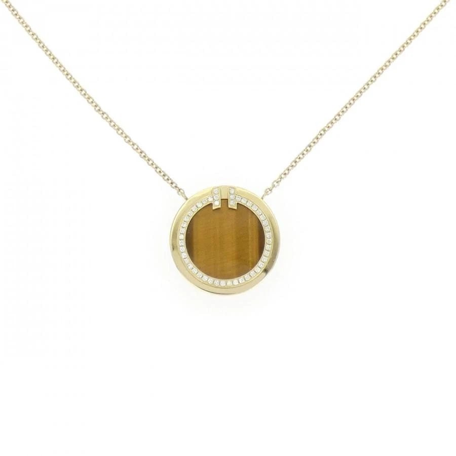 TIFFANY & CO. T CIRCLE TIGER'S EYE DIAMOND NECKLACE: Tiffany & Co. T Circle Tiger's Eye Diamond Necklace Brand: Tiffany & Co. Type/Style: Necklace Material: Metal Purity 750, Metal Yellow Gold, Main Stone/Creation Tiger's Eye/Diamond Color: Yellow Go