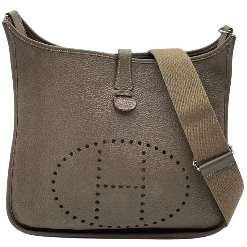 HERMES EVELYNE STAMP ETOUPE SHW CLEMENCE LEATHER SHOULDER BAG: HERMES Evelyne Stamp Etoupe SHW Clemence Leather Shoulder Bag Brand: HERMES Type: Handbag Material: Taurillon Color: Etoupe SV Hardware Size: W: 32cm / H: 30.5cm / D: 7cm / Shoulder: