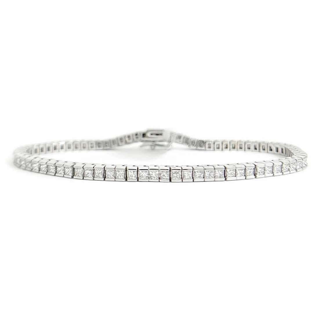 PRINCESS DIAMOND CHANNEL-SET TENNIS BRACELET: Princess Diamond Channel-Set Tennis Bracelet Brand: Unbranded Type: Bracelet Material: 14K white gold, Main Stone/Creation Natural Color: Silver Size: Length: 7.25 inches Width: 3.2 mm 