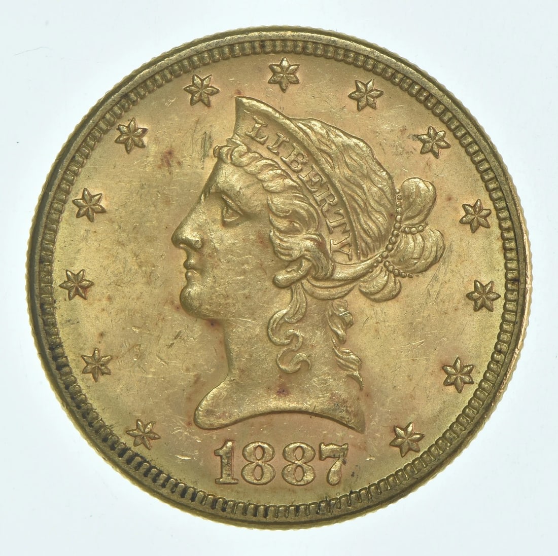 1887 $10 LIBERTY HEAD GOLD EAGLE: 1887 $10 Liberty Head Gold Eagle Brand/Mint: None Year: 1887 Fineness: None Denomination: $10 Country of Origin: United States Accessories: None Accessories Notice: When purchasing pre-owned